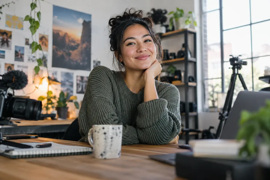 A smiling creative producer photographed in soft natural light